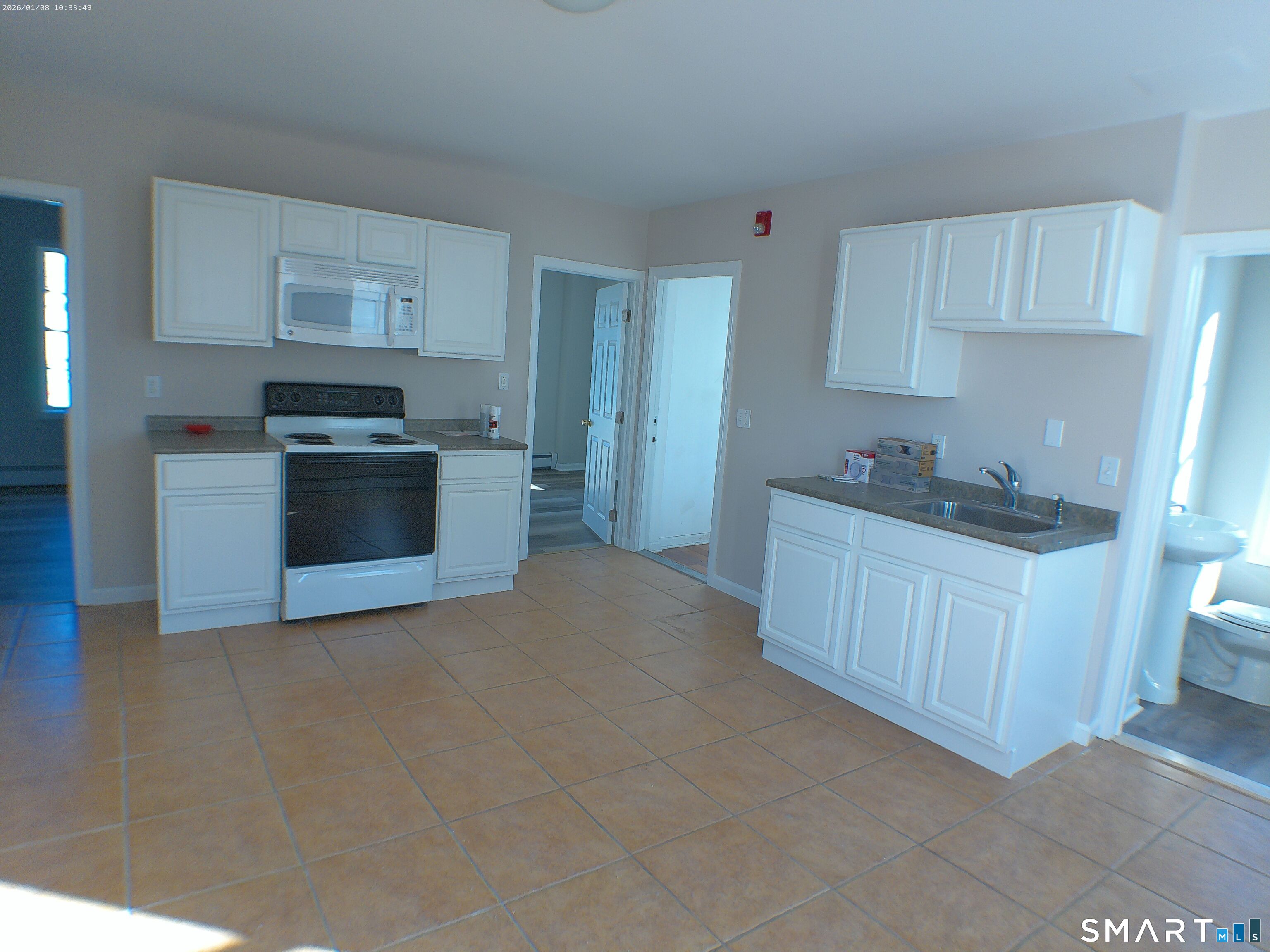 85 North Colony Street Wallingford, CT 06492 - Photo 14 of 35 a kitchen with stainless steel appliances white cabinets a sink a stove a refrigerator and cabinets