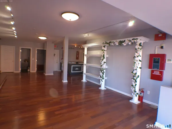 a view of a room with wooden floor and windows