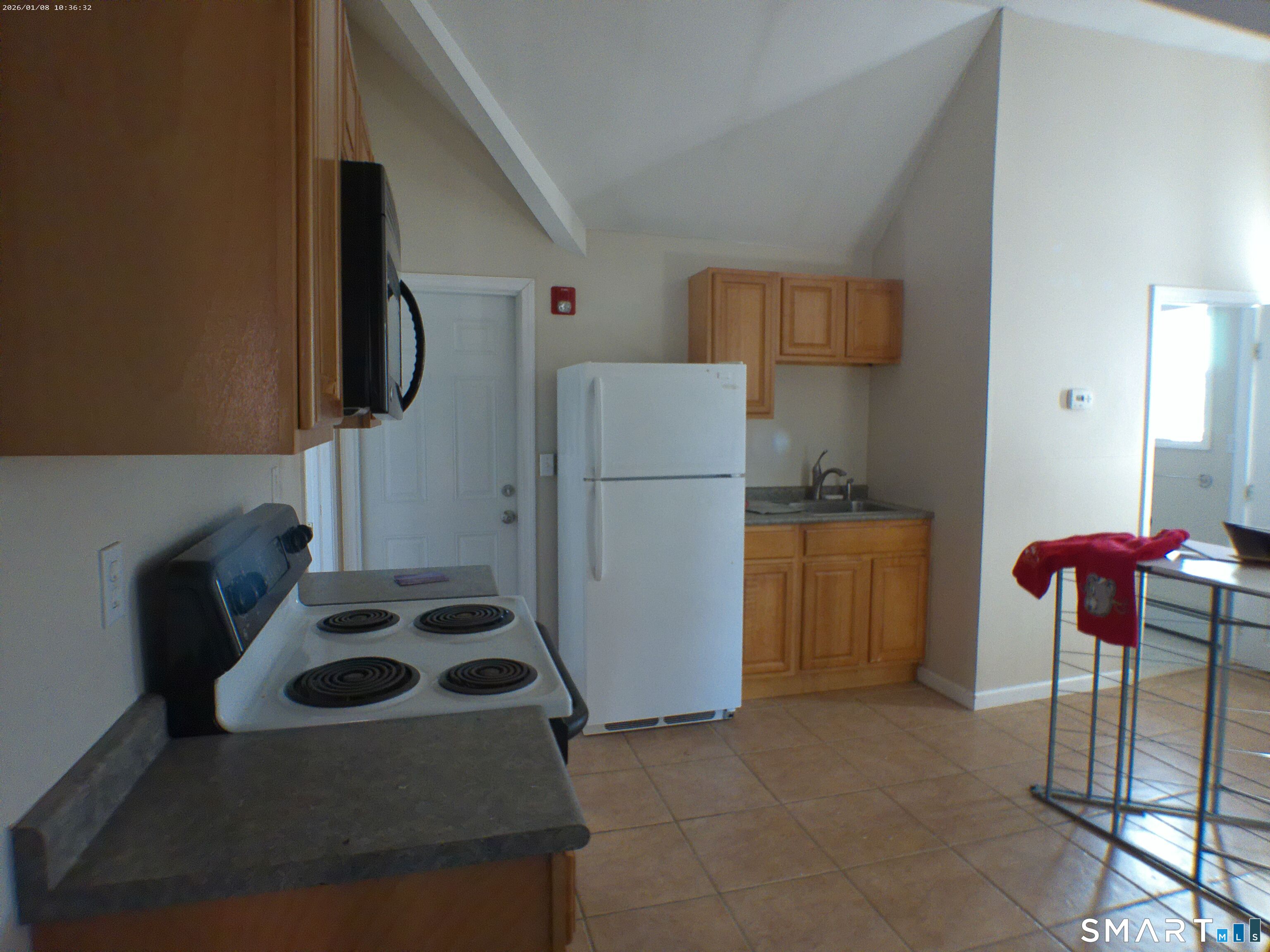 85 North Colony Street Wallingford, CT 06492 - Photo 27 of 35 a kitchen with a refrigerator and white cabinets