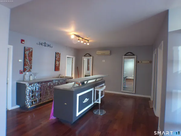 a kitchen with stainless steel appliances granite countertop a stove and a wooden floors