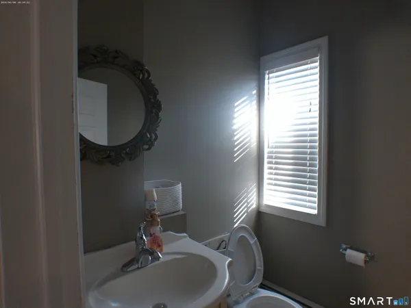 a bathroom with a sink toilet and a mirror