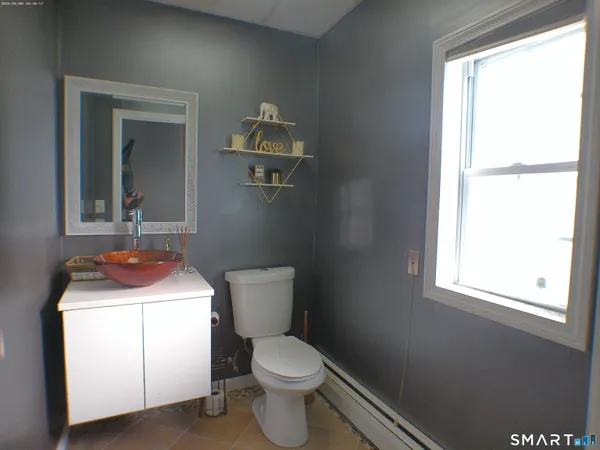 a bathroom with a toilet sink and mirror