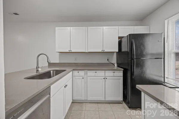 a kitchen with a sink and a refrigerator
