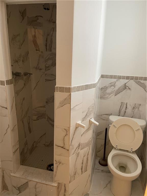 1423 Schenectady Avenue Brooklyn, NY 11203 - Photo 20 of 45 a bathroom with a toilet and a shower