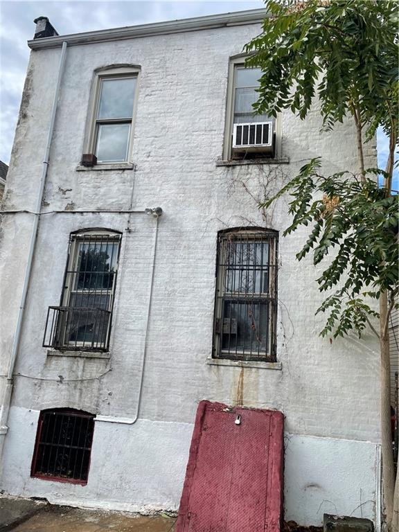 1423 Schenectady Avenue Brooklyn, NY 11203 - Photo 36 of 45 a living room with a fireplace and a potted plant