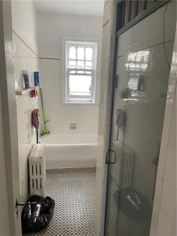 1423 Schenectady Avenue Brooklyn, NY 11203 - Photo 39 of 45 a bathroom with a bathtub and a shower