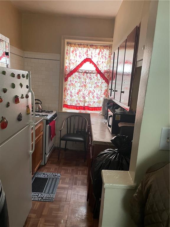 1423 Schenectady Avenue Brooklyn, NY 11203 - Photo 40 of 45 a kitchen with stainless steel appliances a stove a sink and a window