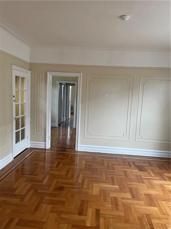 1423 Schenectady Avenue Brooklyn, NY 11203 - Photo 7 of 45 a view of a hallway with wooden floor and a cabinet