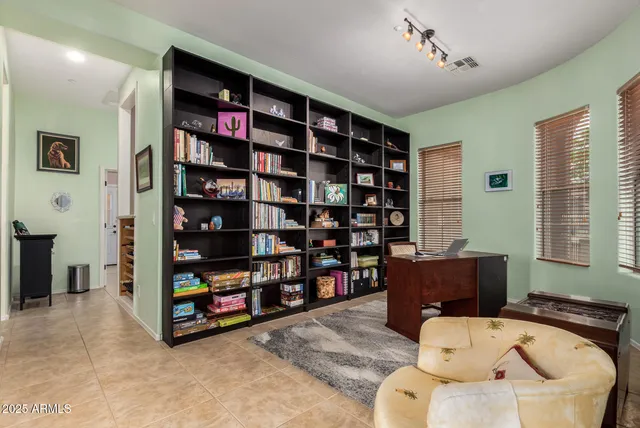 a view of a dining room with furniture a rug and wooden floor