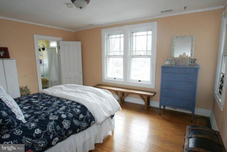 223 Hawthorn Road Baltimore, MD 21210 - Photo 19 of 30 a bedroom with a bed and wooden floor