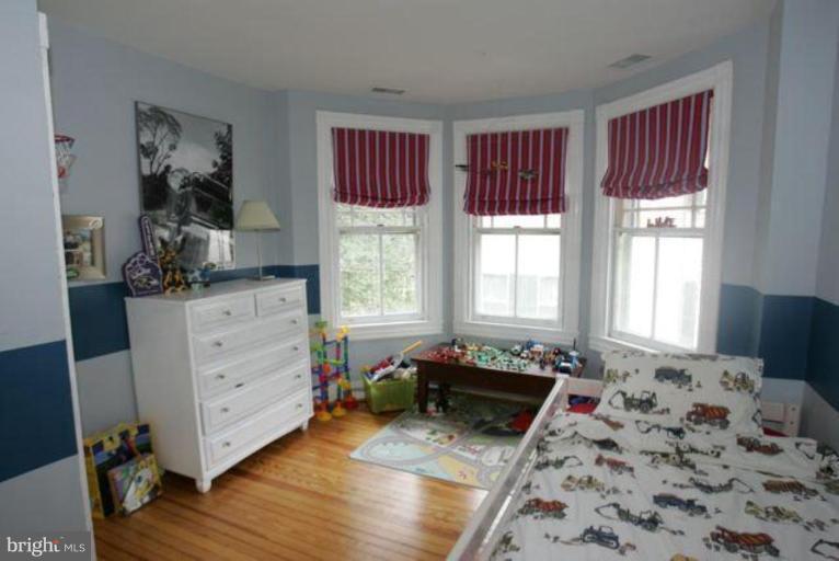 223 Hawthorn Road Baltimore, MD 21210 - Photo 20 of 30 a bed room with a bed and a dresser