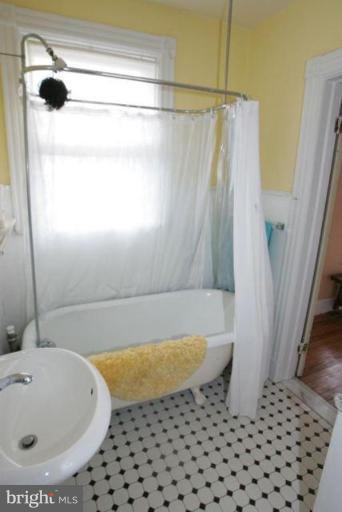 223 Hawthorn Road Baltimore, MD 21210 - Photo 30 of 30 a bathroom with a bathtub and shower