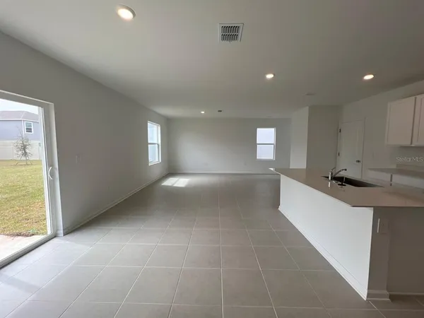 a large kitchen with kitchen island a sink stainless steel appliances and a cabinets