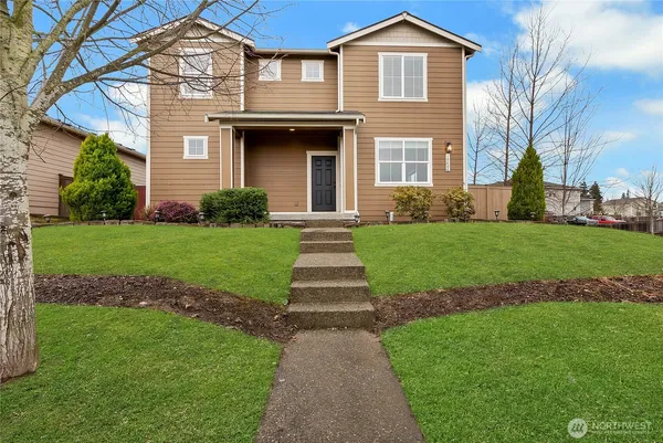 a front view of a house with a yard