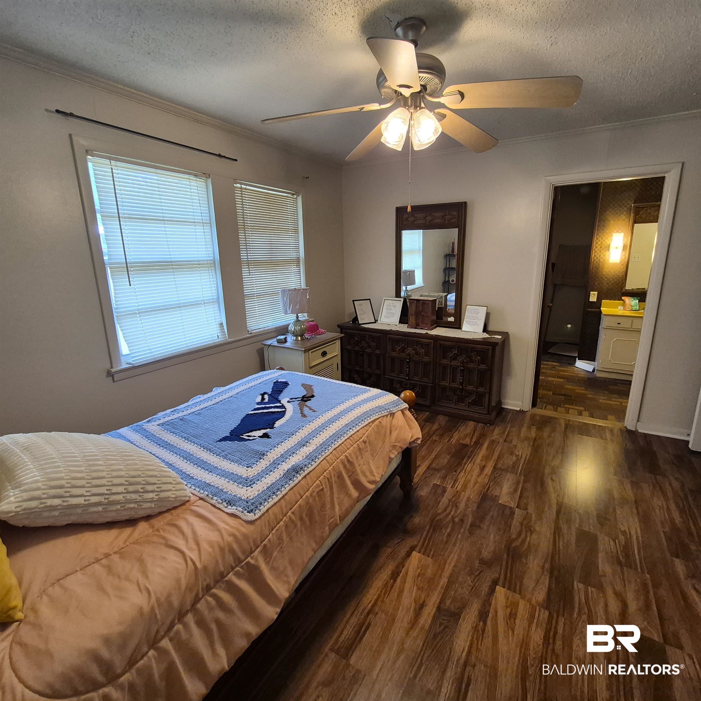 108 Azalea Street Evergreen, AL 36401 - Photo 13 of 19 Warm wood-finish flooring complements the room's neutral wall tones