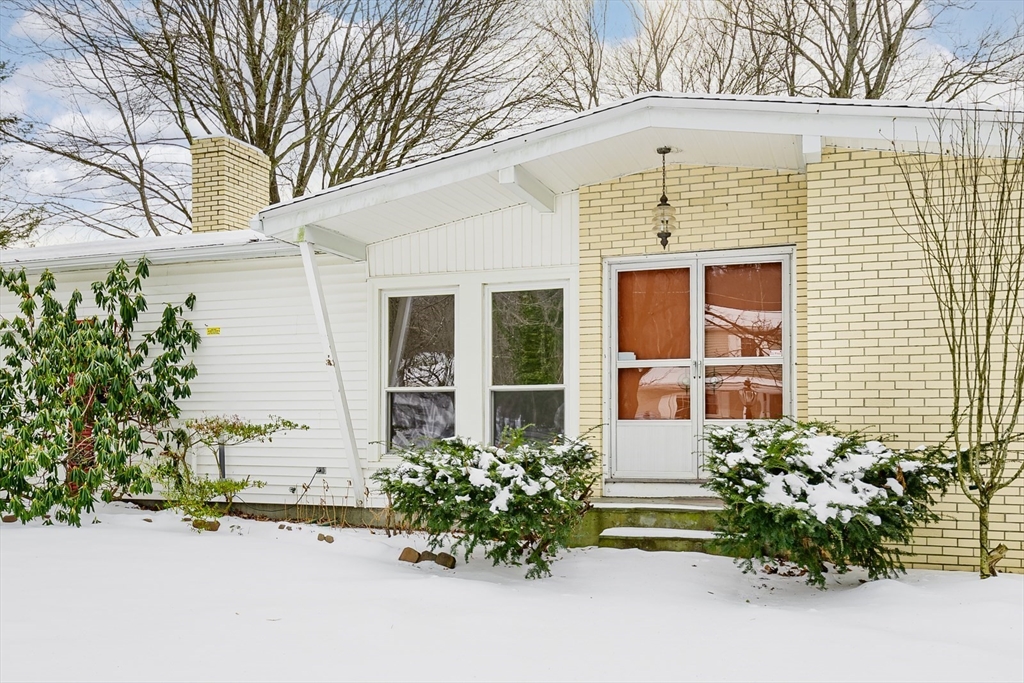 9 Cloverleaf Road Leominster, MA 01453 - Photo 1 of 19 front view of a brick house with a large window and potted plants