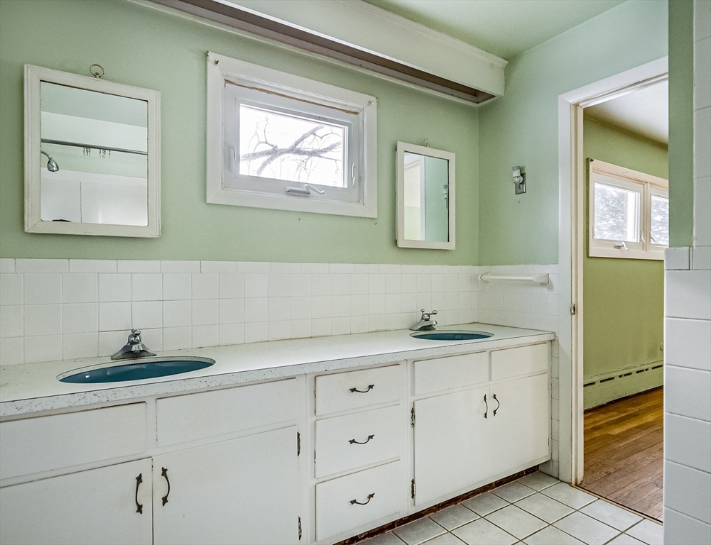 9 Cloverleaf Road Leominster, MA 01453 - Photo 14 of 19 a bathroom with a granite countertop sink and a mirror
