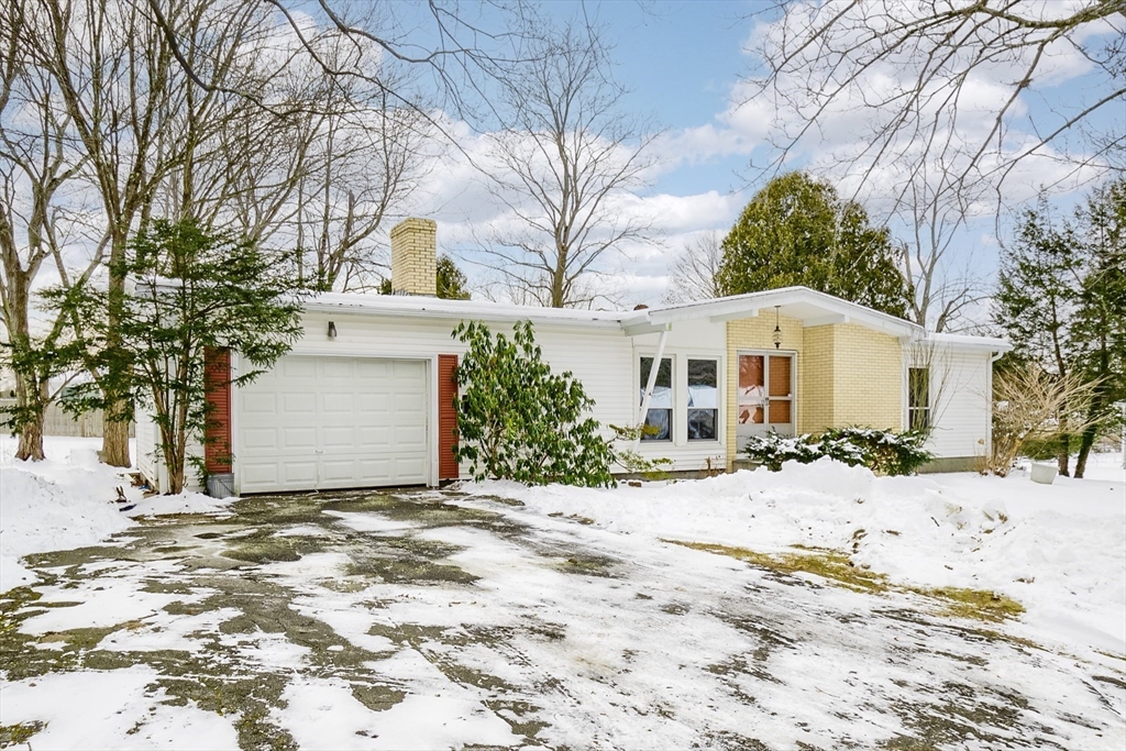 9 Cloverleaf Road Leominster, MA 01453 - Photo 5 of 19 a view of a white house with a yard covered with snow