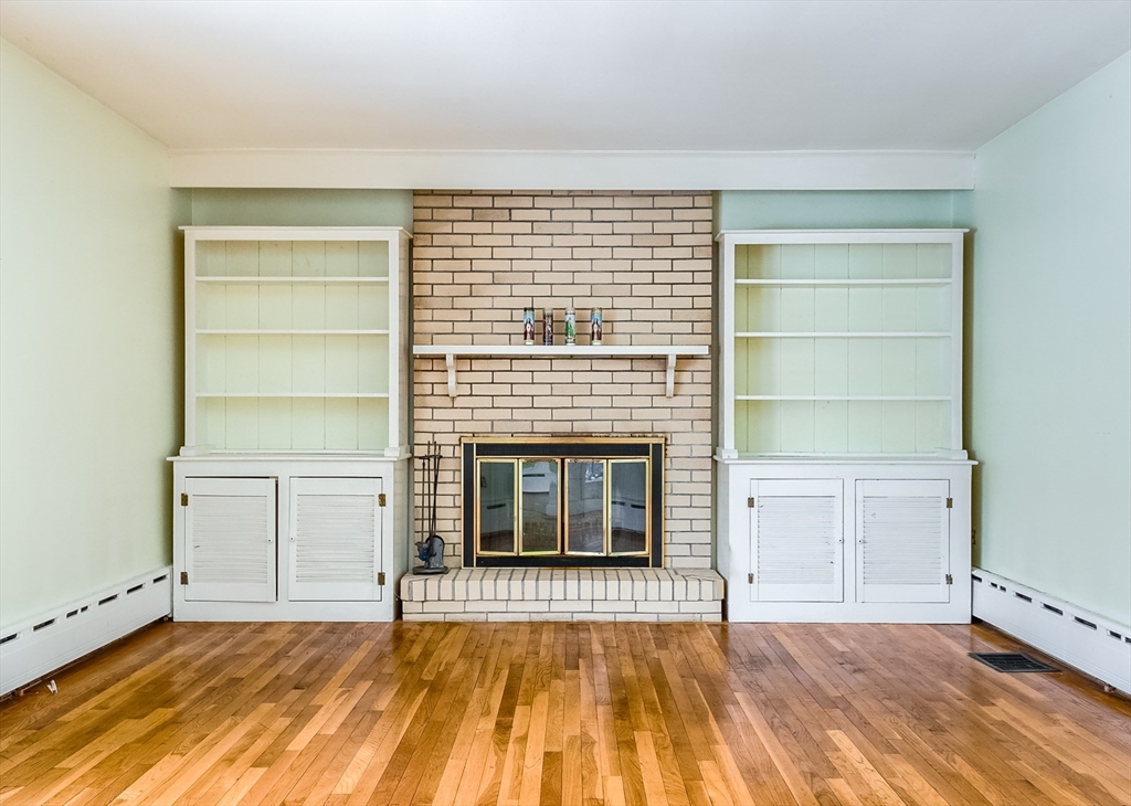 9 Cloverleaf Road Leominster, MA 01453 - Photo 10 of 19 a view of empty room with a fireplace and wooden floor