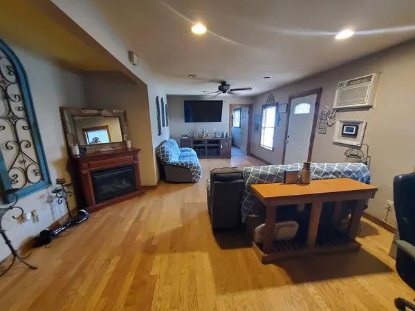 a living room with patio furniture and a flat screen tv