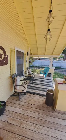 a view of a patio with table and chairs