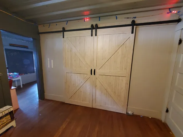 a view of walk in closet with wooden floor