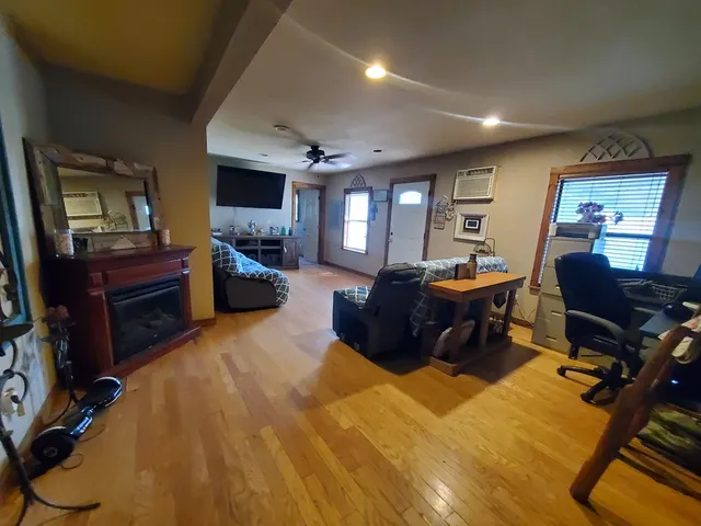 a living room with furniture a piano and a flat screen tv