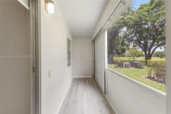 a view of a porch with wooden floor and a yard