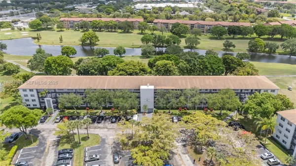 an aerial view of residential houses with outdoor space and river