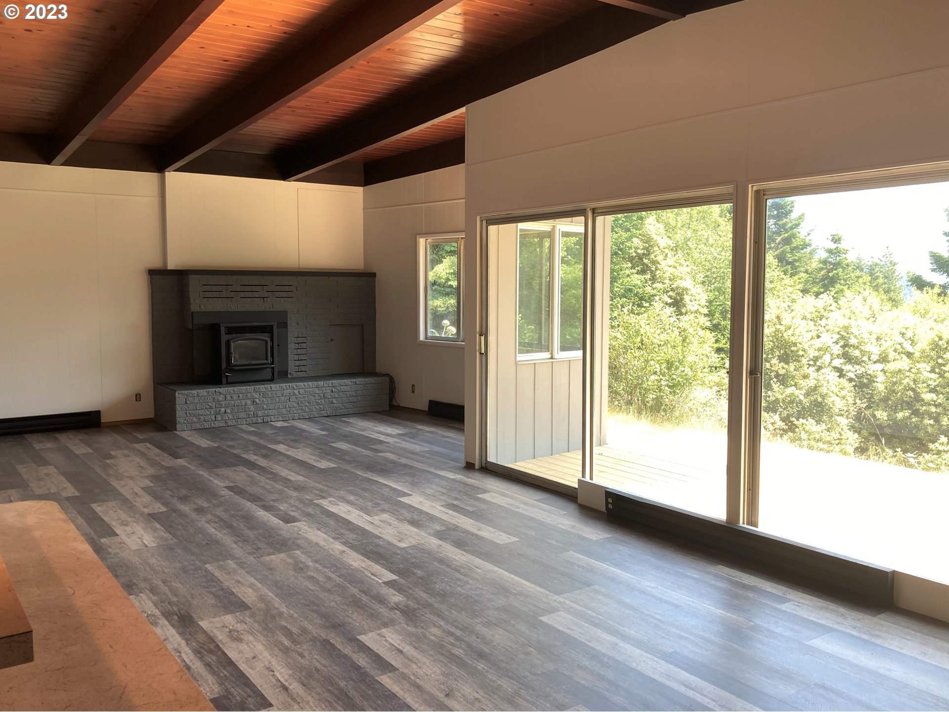 95144 Marchmont Road Gold Beach, OR 97444 - Photo 3 of 34 a view of empty room with wooden floor and fireplace