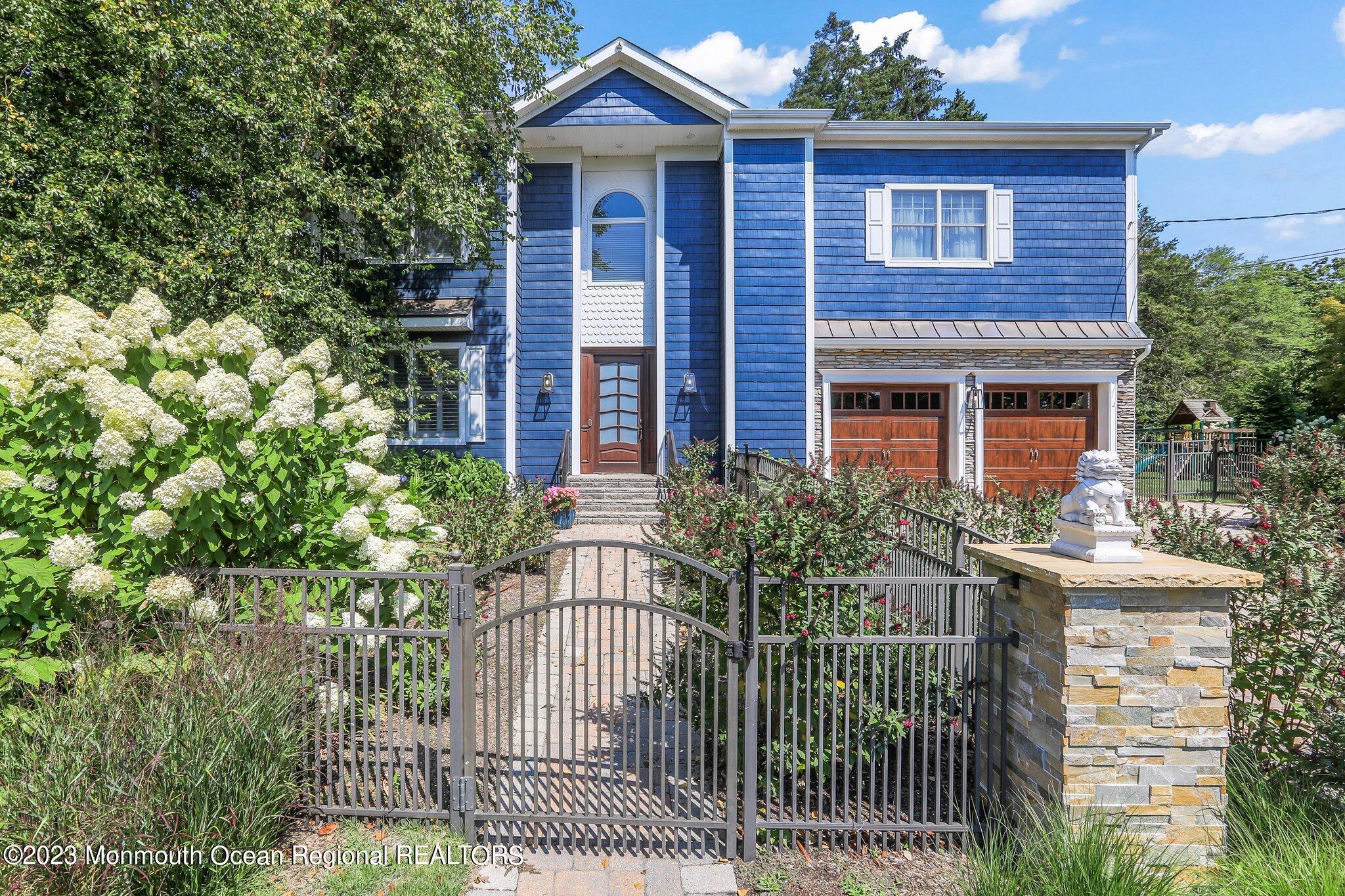 2604 River Road Manasquan, NJ 08736 - Photo 3 of 62 a front view of a house with a garden