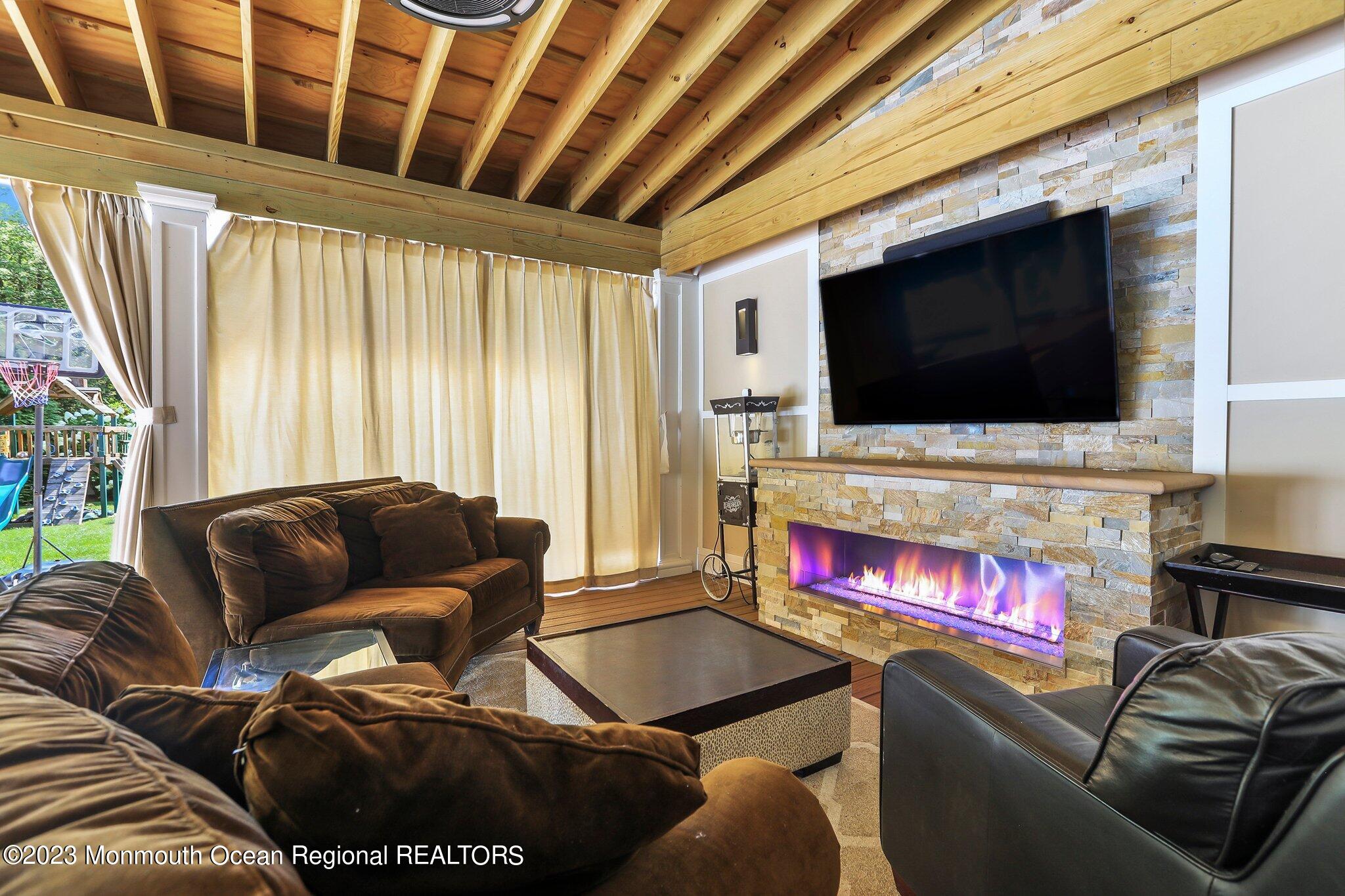 2604 River Road Manasquan, NJ 08736 - Photo 8 of 62 a living room with furniture and a flat screen tv