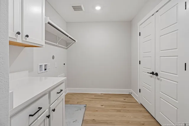 a view of a storage and utility room with closet