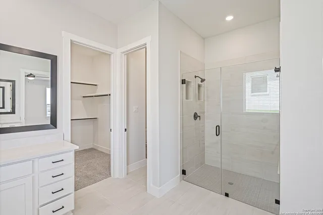 a bathroom with a shower and a sink