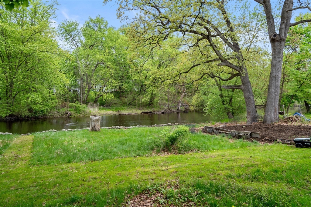 26 Powder Mill Road Maynard, MA 01754 - Photo 11 of 16 a view of a lake with a yard