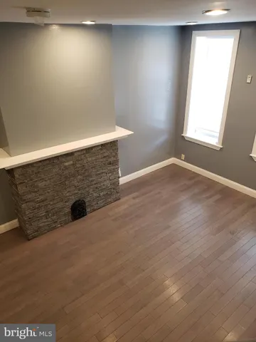 an empty room with wooden floor