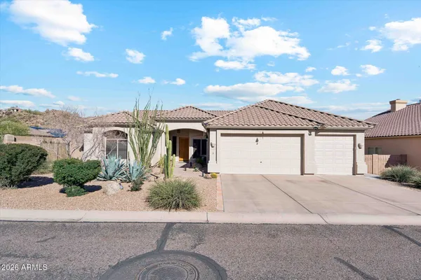 a view of a house with a yard and garage