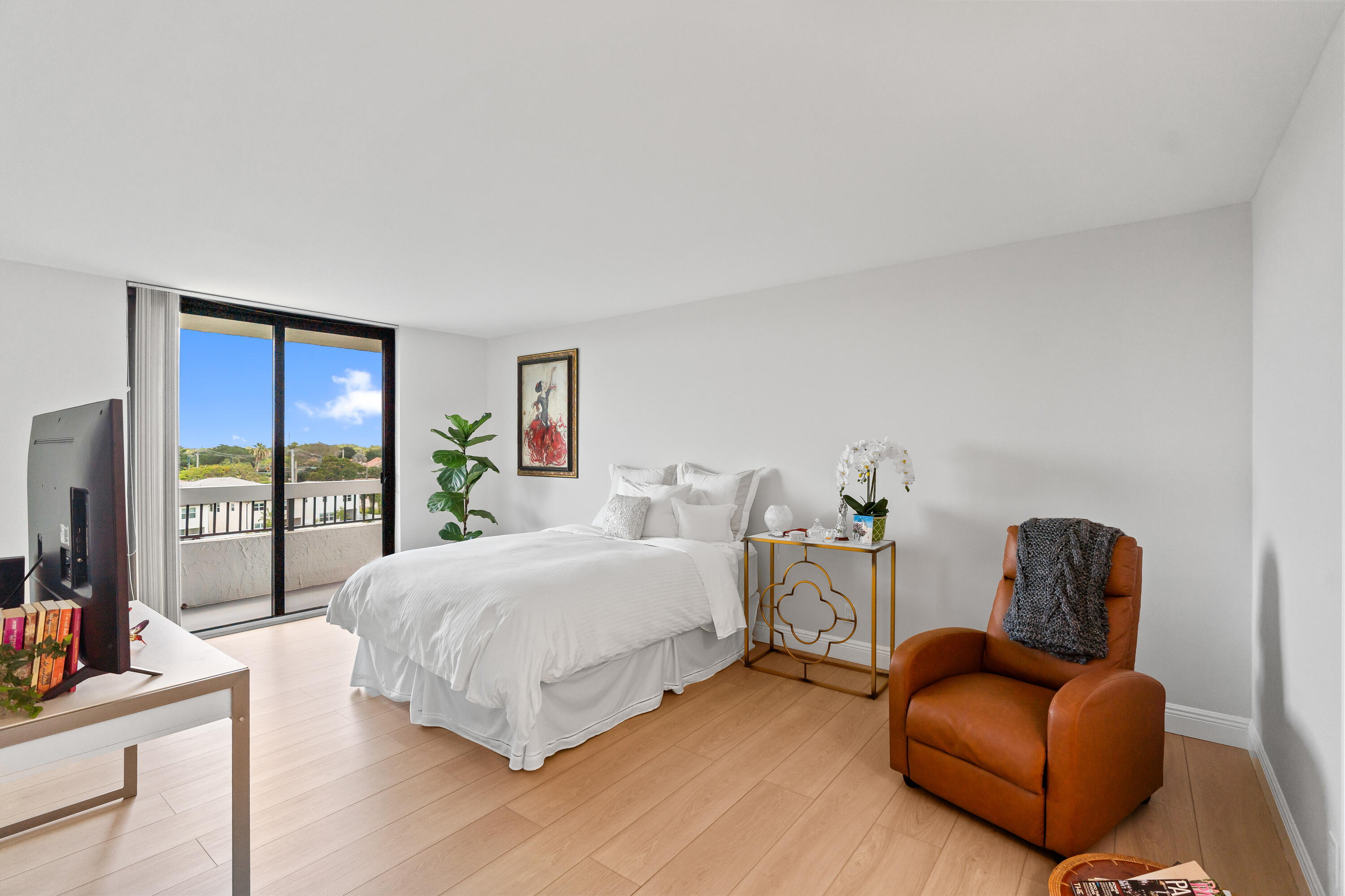 23200 Camino Del Mar, Unit 603 Boca Raton, FL 33433 - Photo 16 of 43 a bedroom with a bed couch and a large window