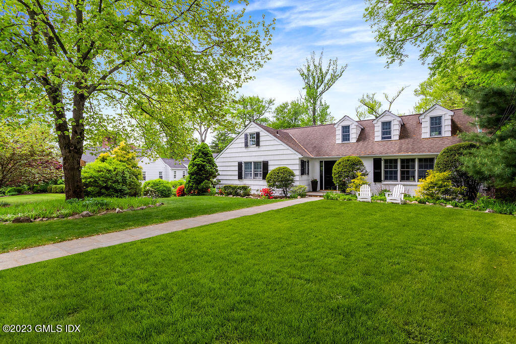 a front view of a house with a garden and porch