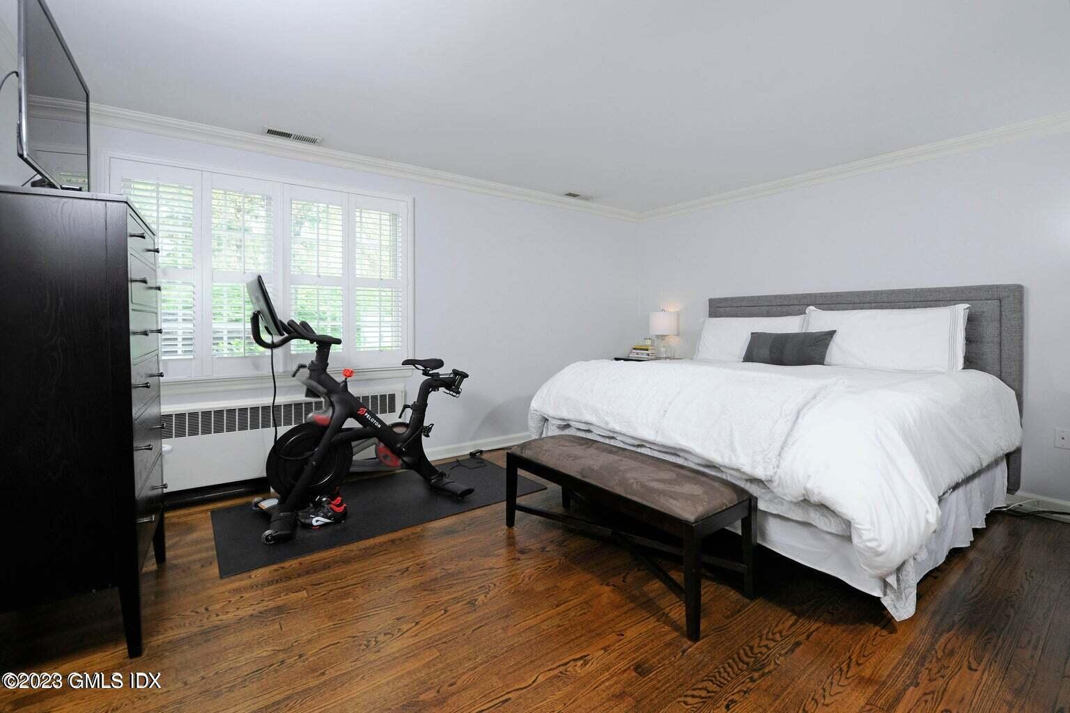 16 Crescent Road Riverside, CT 06878 - Photo 12 of 33 a bedroom with a bed a table and wooden floor