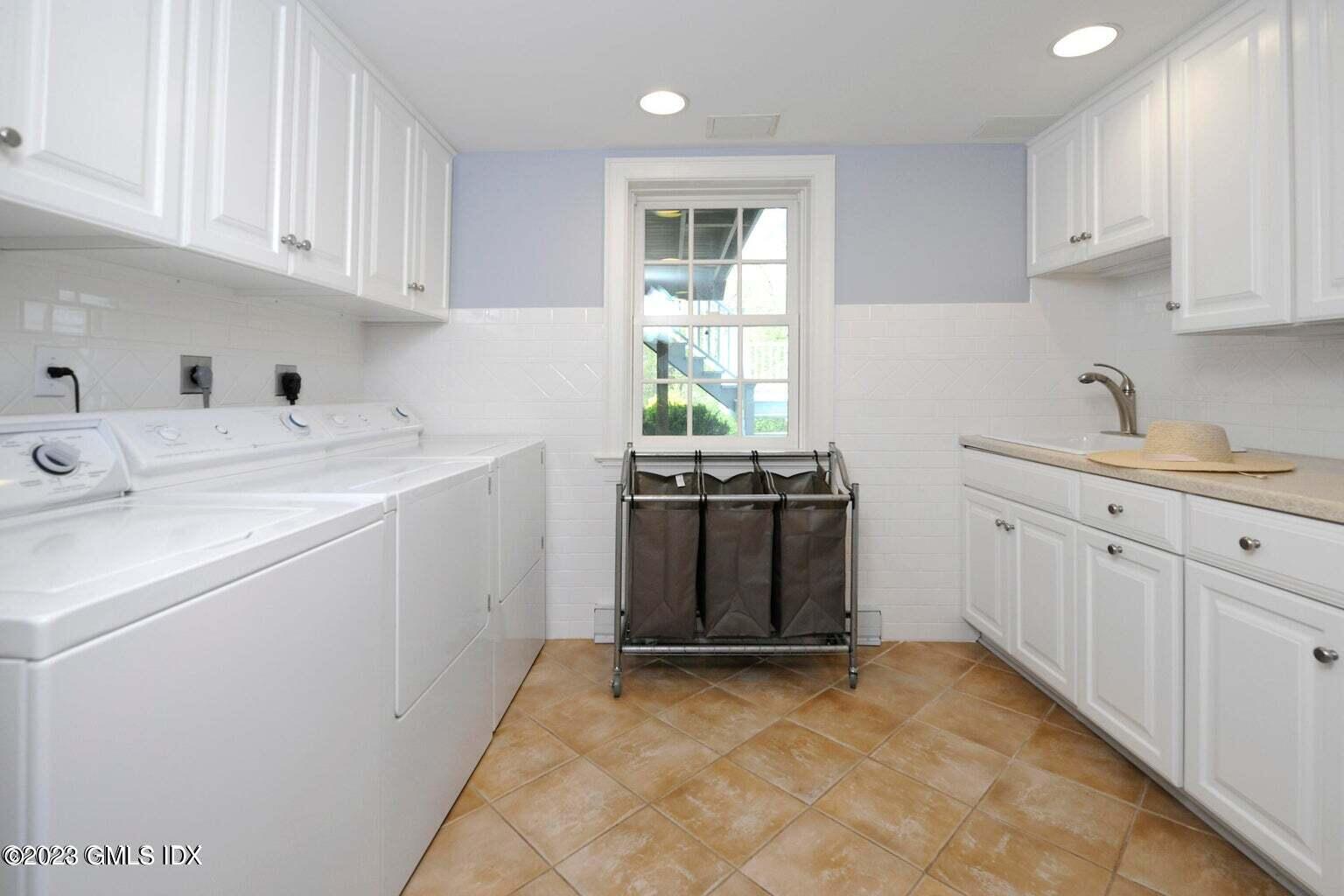 16 Crescent Road Riverside, CT 06878 - Photo 16 of 33 a utility room with cabinets washer and dryer