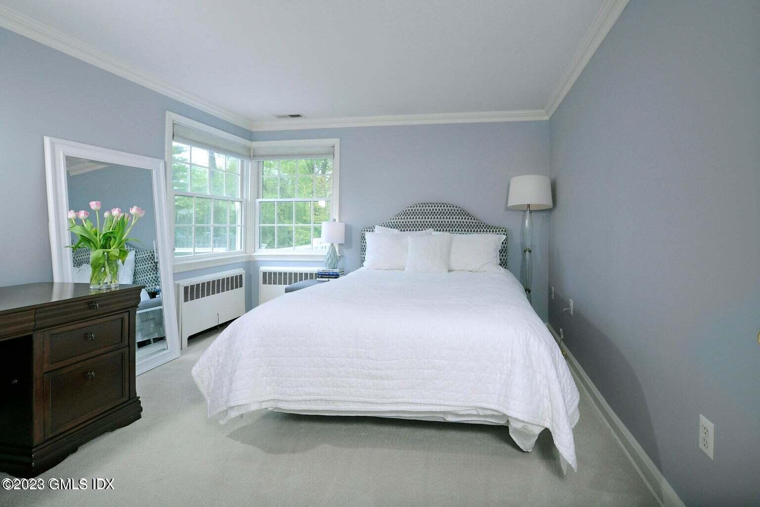 16 Crescent Road Riverside, CT 06878 - Photo 19 of 33 a bedroom with a bed and a large window