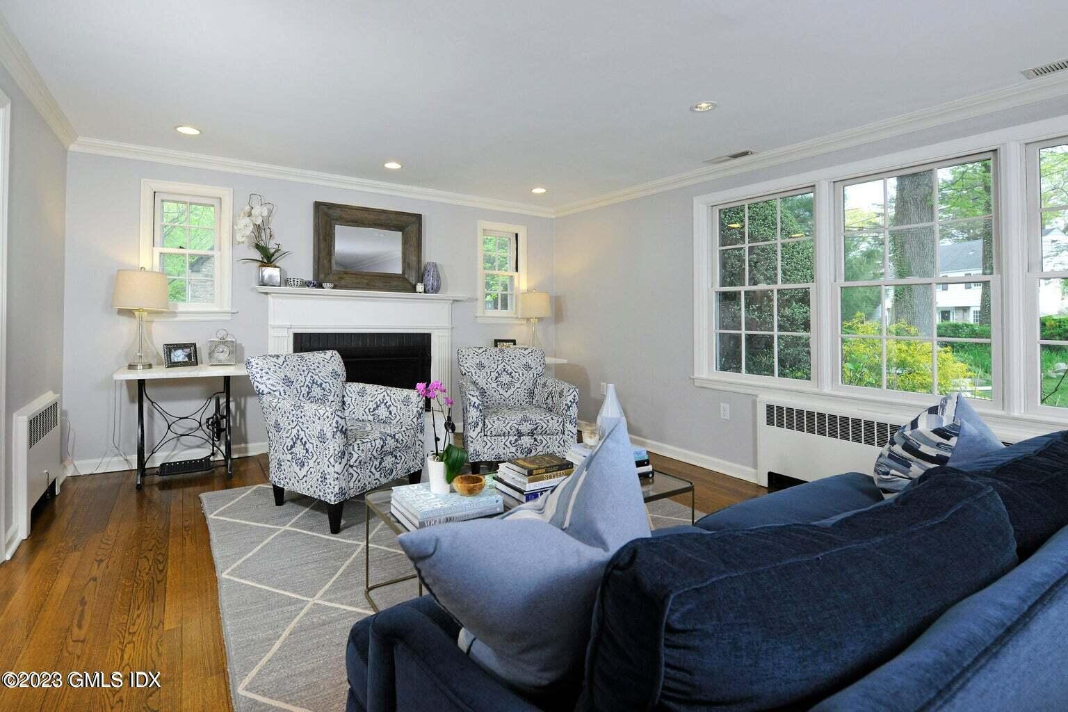 16 Crescent Road Riverside, CT 06878 - Photo 4 of 33 a living room with furniture and a fireplace