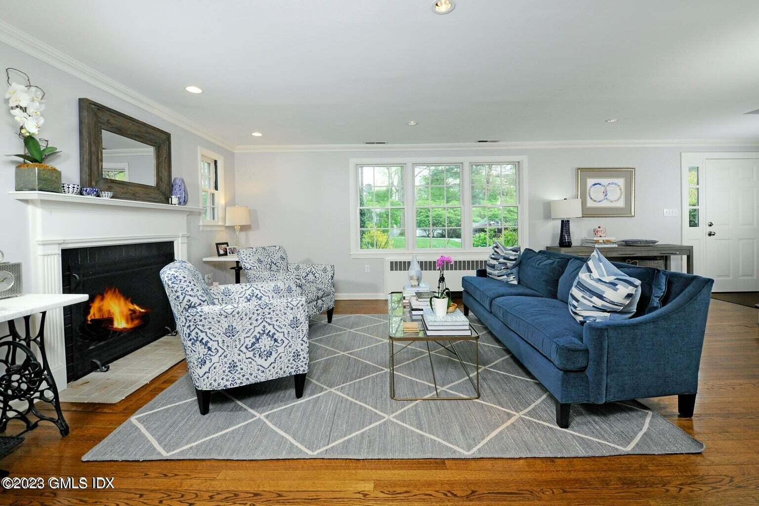 16 Crescent Road Riverside, CT 06878 - Photo 5 of 33 a living room with furniture and a fireplace