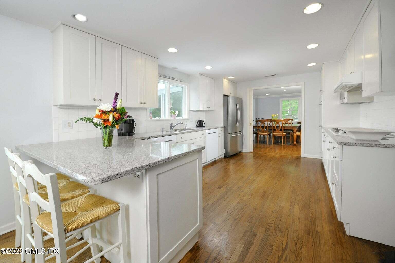 16 Crescent Road Riverside, CT 06878 - Photo 8 of 33 a kitchen with stainless steel appliances granite countertop sink stove refrigerator and wooden floor