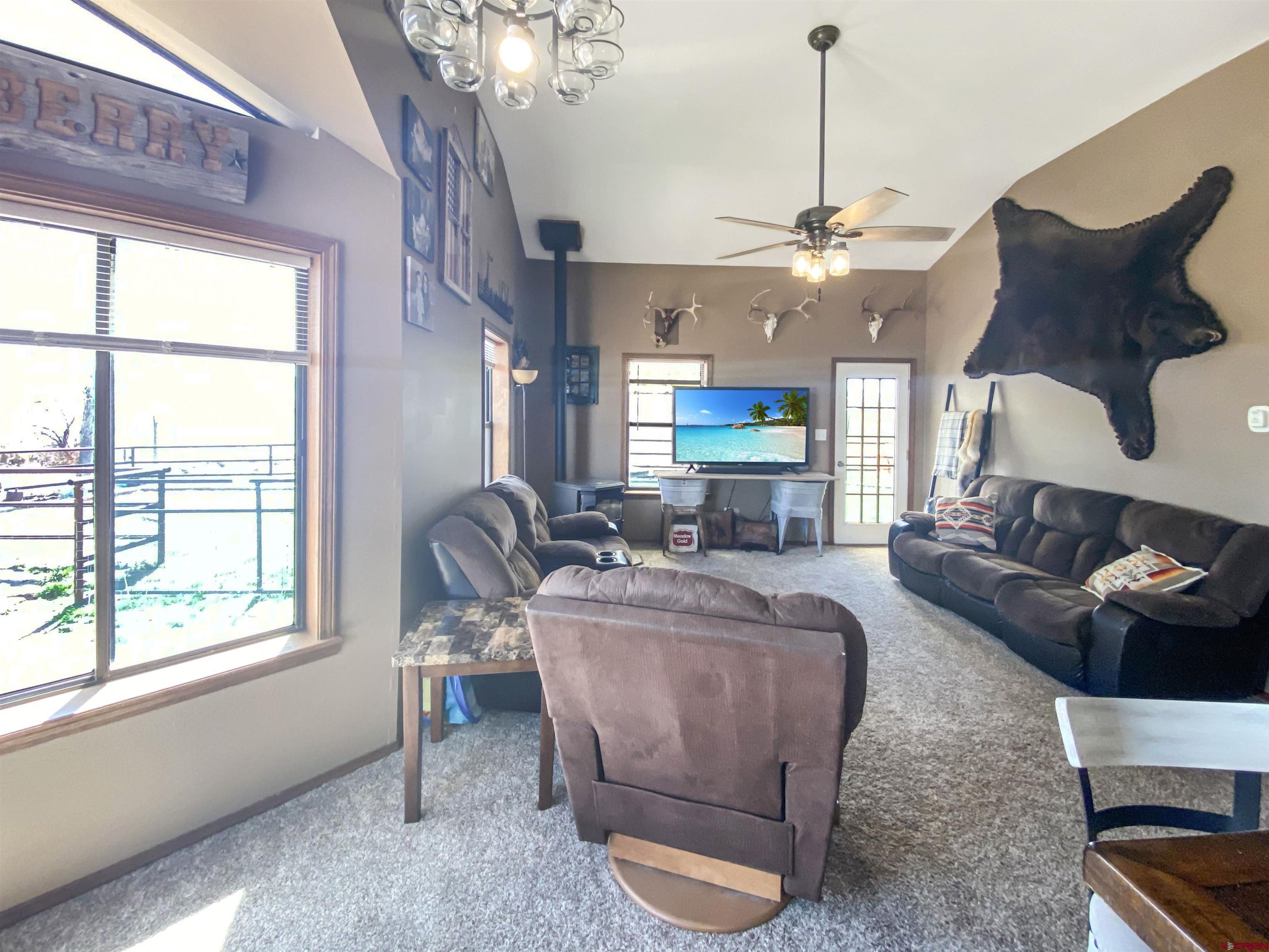 24020 County Rd M Cortez, CO 81321 - Photo 8 of 18 a living room with furniture a chandelier and a fireplace