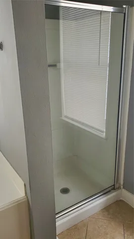 a bathroom with a glass shower door