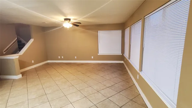a view of a livingroom with a ceiling fan and window