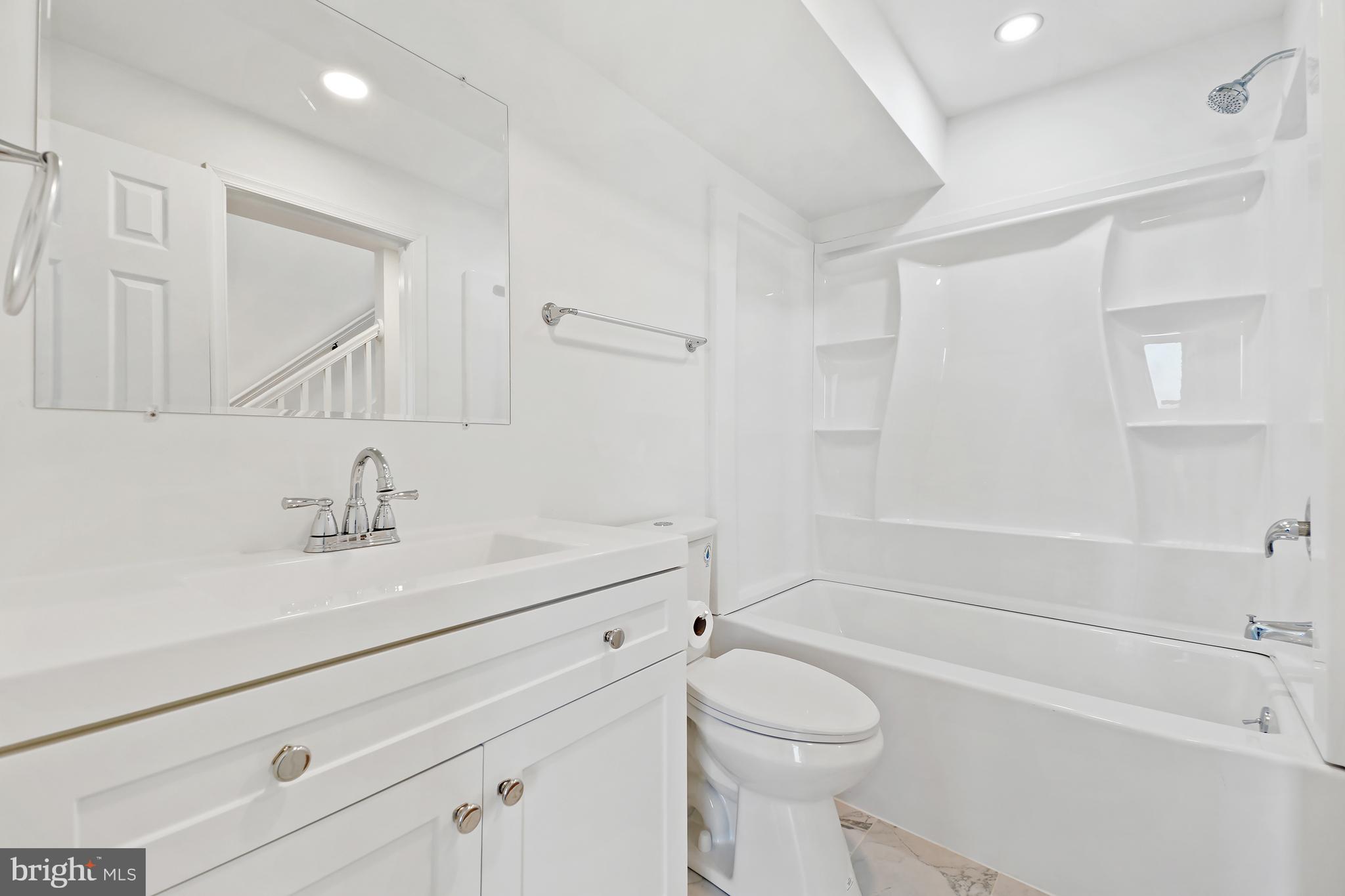 3731 Falls Road Baltimore, MD 21211 - Photo 20 of 30 a bathroom with a sink a toilet and shower