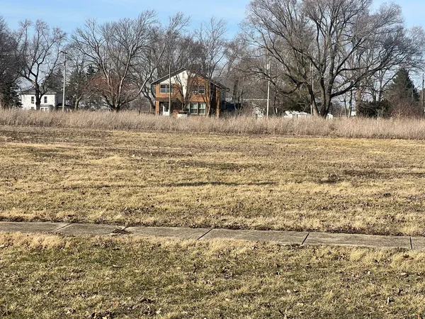 a view of yard covered with snow in front of house